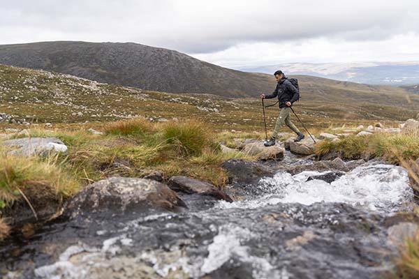 hiking poles for beginners - man hiking with poles