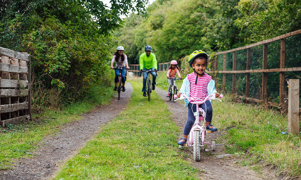 family cycling outdoors locally