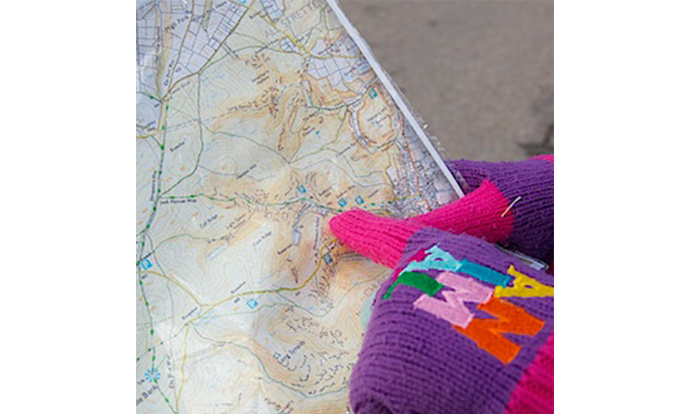childs hand on map