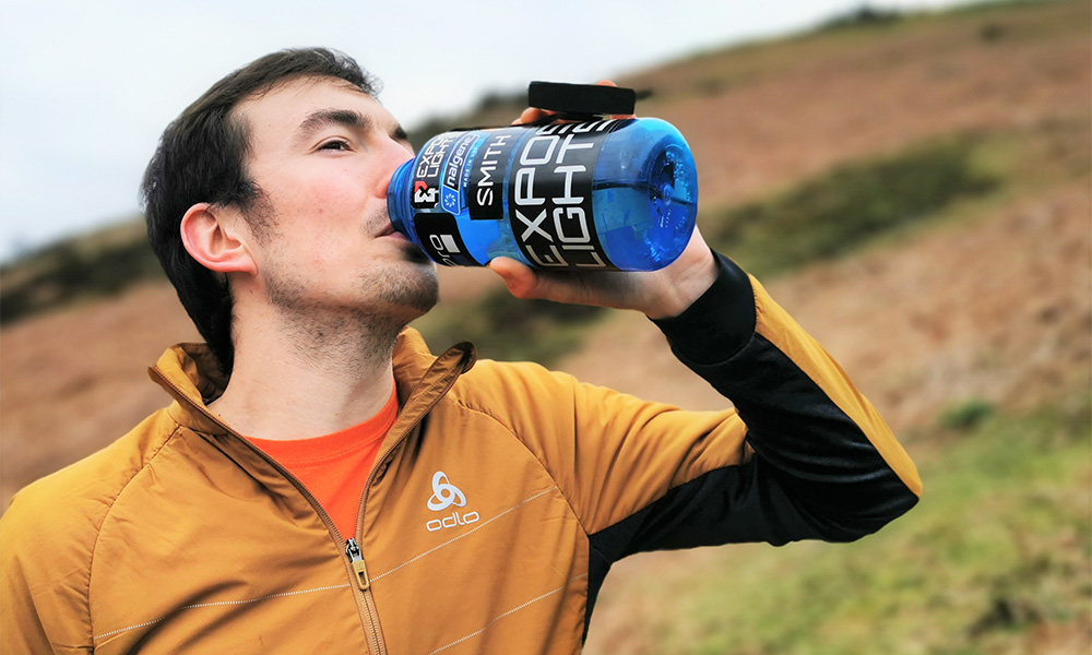 Tim drinking from a large bottle