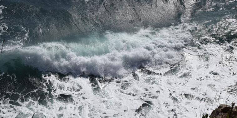 Waves hitting a cliff, taken form above