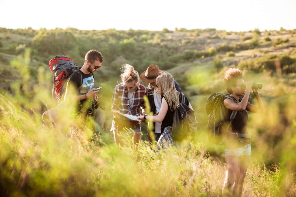 hiking for beginners - a group of hikers looking at a map