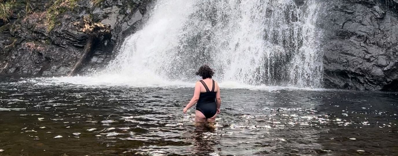 wild swimming by a waterfall