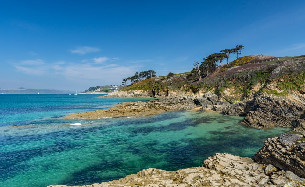 pretty bay with blue water on the south west coast path cornwall