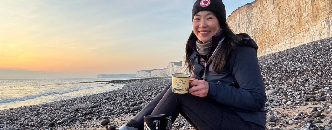 May Cheung drinking coffee on Birling Gap Walk