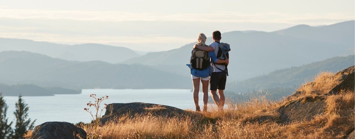 explore lake district couple looking at lake