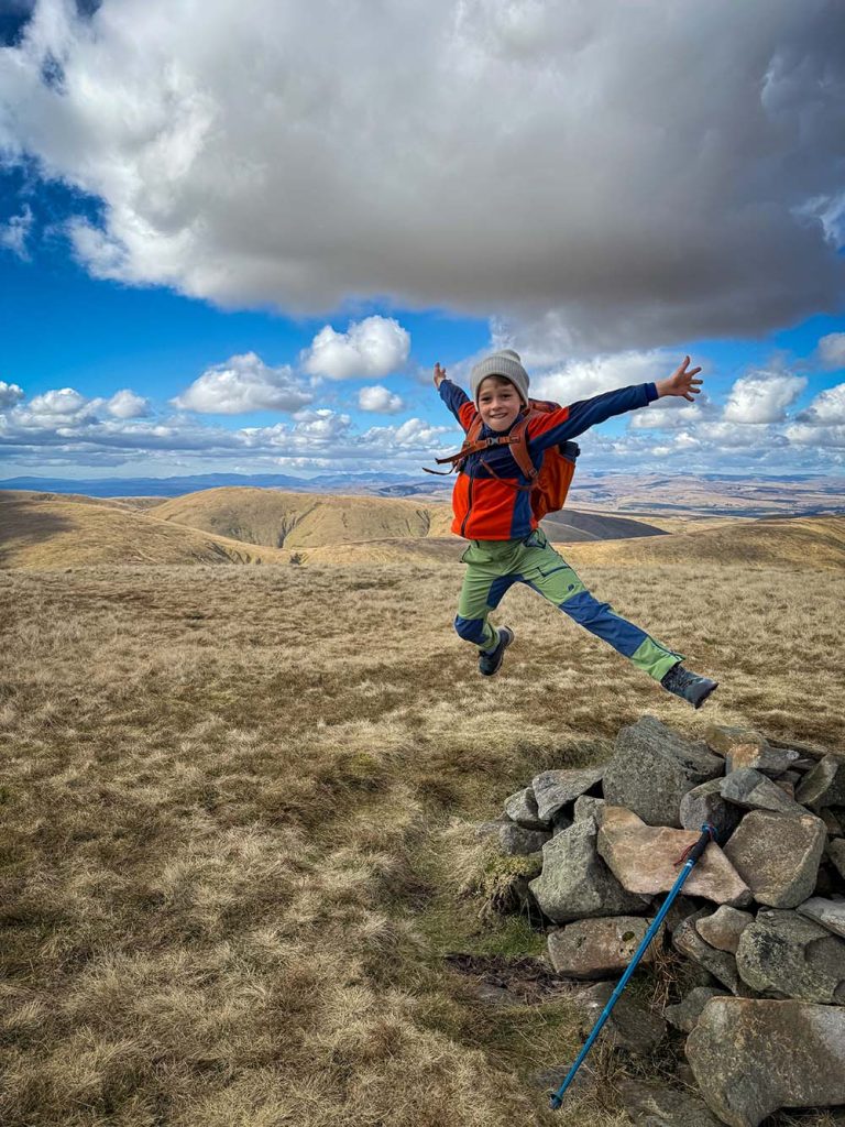a boy jumping in the Howgills