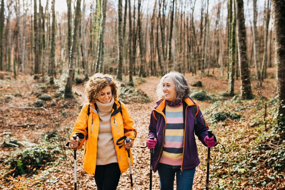hiking confidence - a pair of mature women hiking in the woods