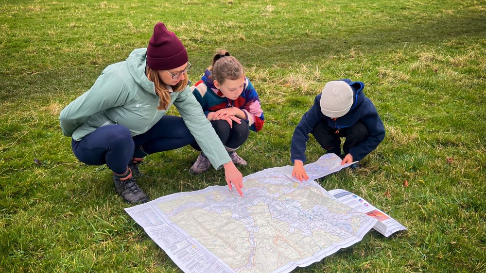 building outdoor confidence kids and mum reading a map together