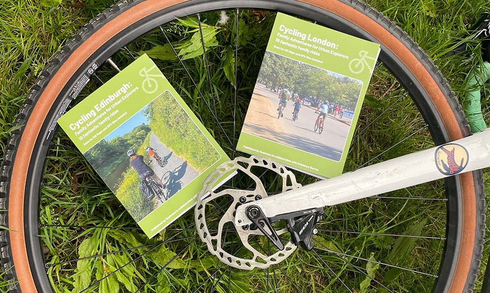 City Cycling Guide Books on a bicycle wheel