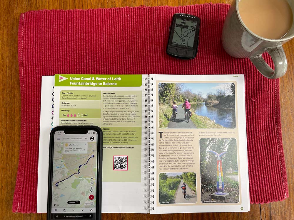 showing the cycling guide book with a phone and gps device