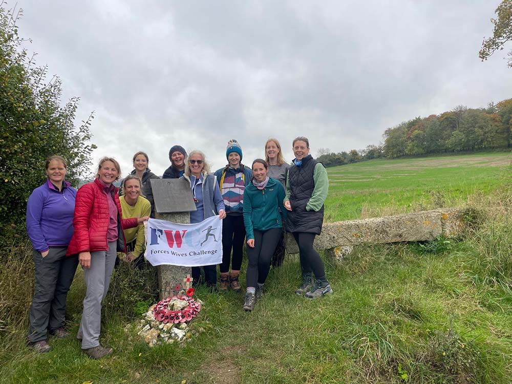 Forces wives poppy hikes - group of women hiking with a banner
