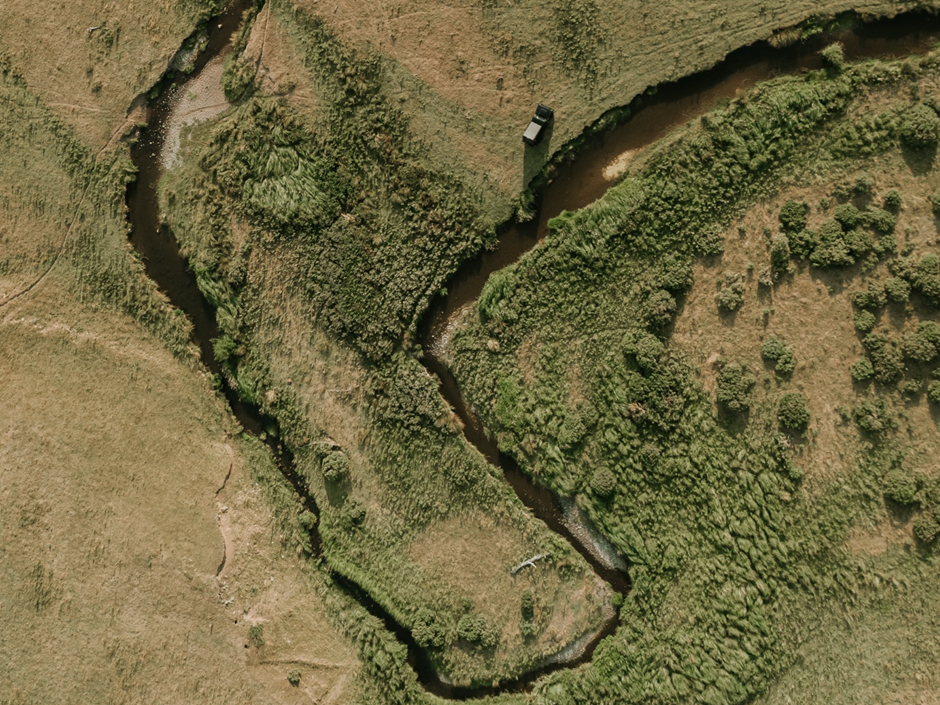 a river running through fields an aerial view