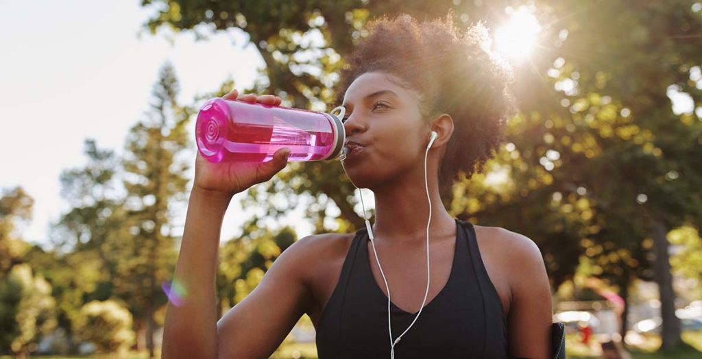 Runner drinking from a water bottle