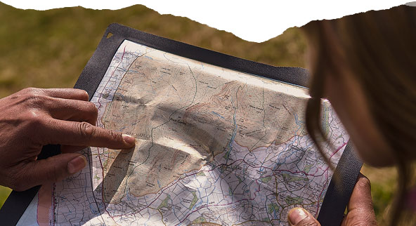 Closeup of a person looking at a printed map