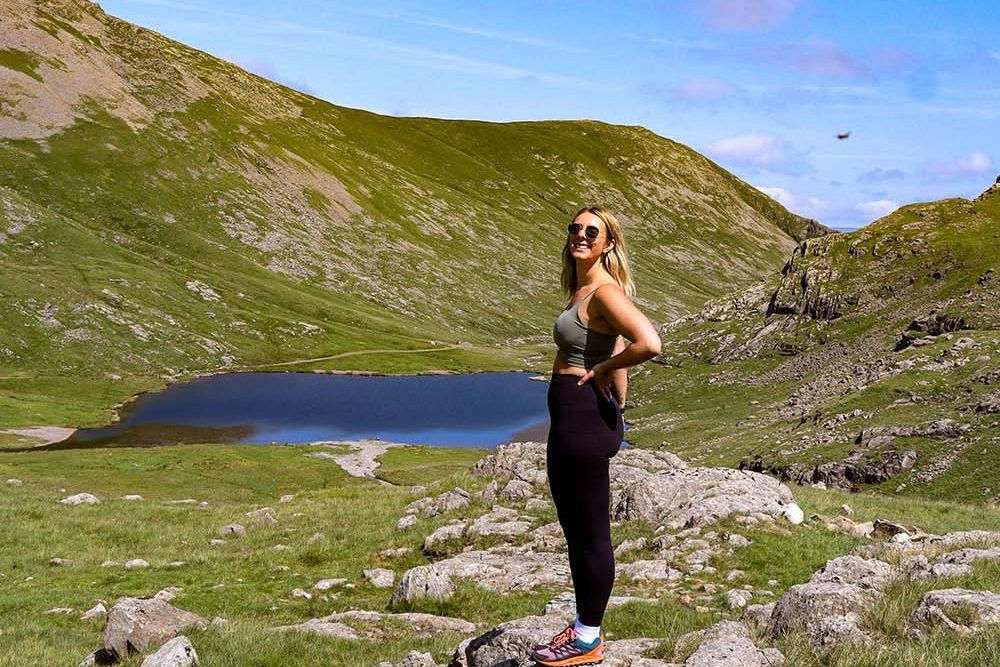 Sophie davis in front of a lake in the mountains