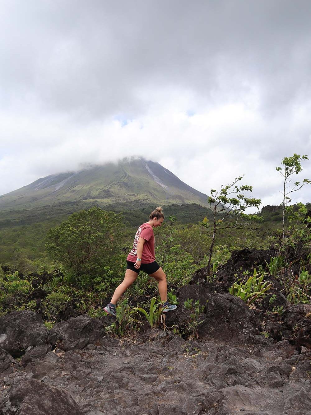 sophie walking with a cloud shrouded mountain in the background