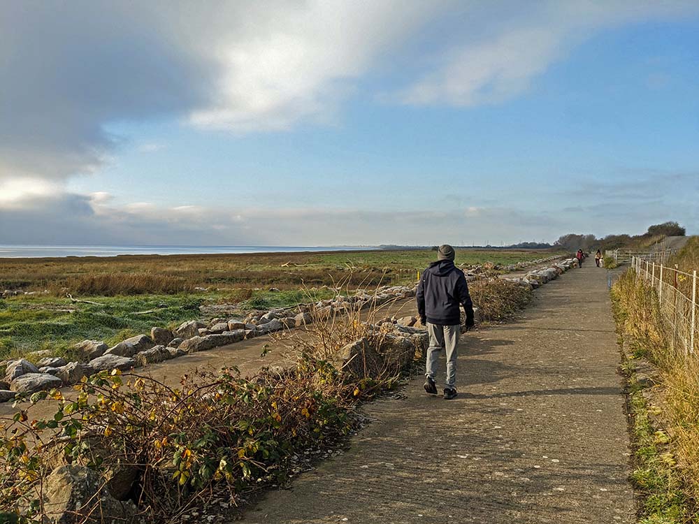 Caldicot to Sudbrook rd - man walking on a concrete track