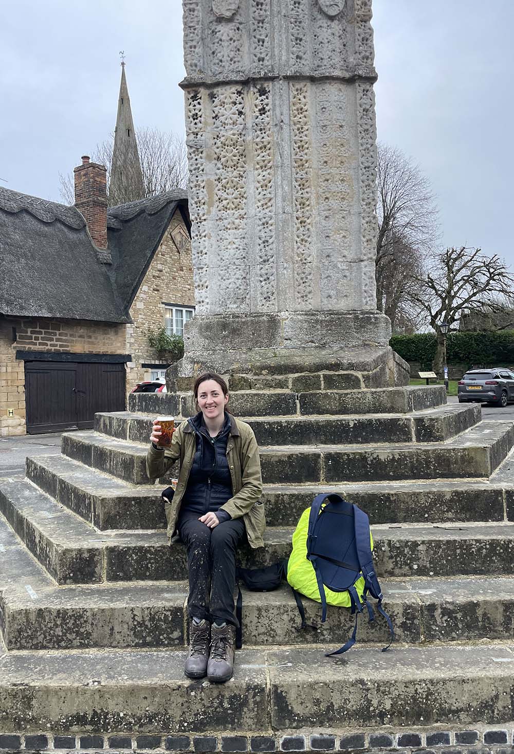 A well deserved pint on the steps of the Eleanor Cross in Geddington