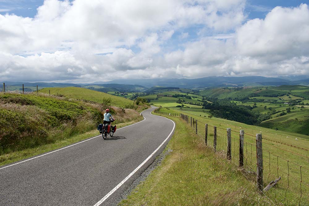 national cycle network route 8 - cycling down a hill into a valley