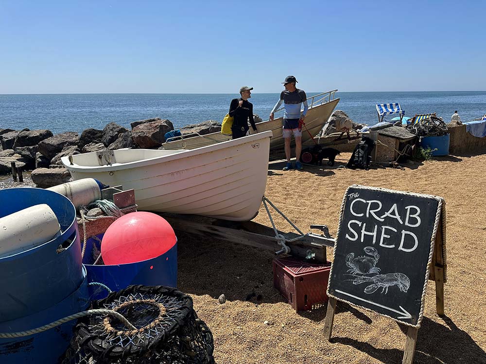 crab sign on a beach with fishing boats