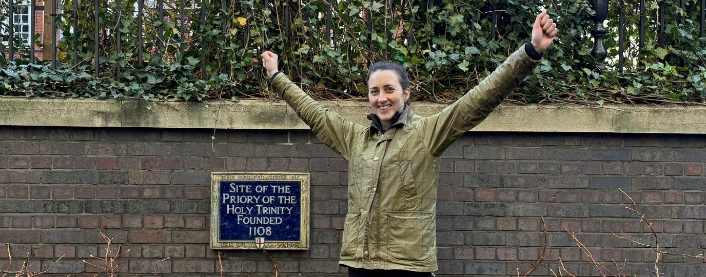Alice loxton in front of a plaque