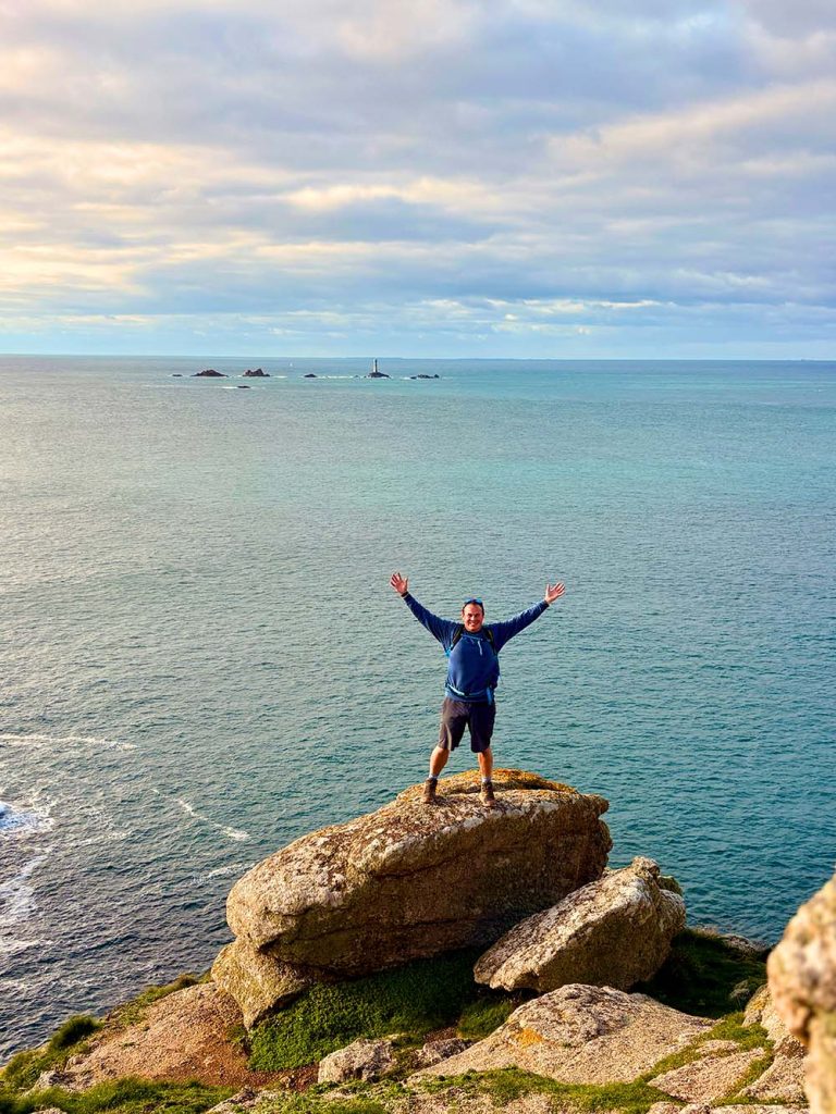 a man stood on a rock in cornwall