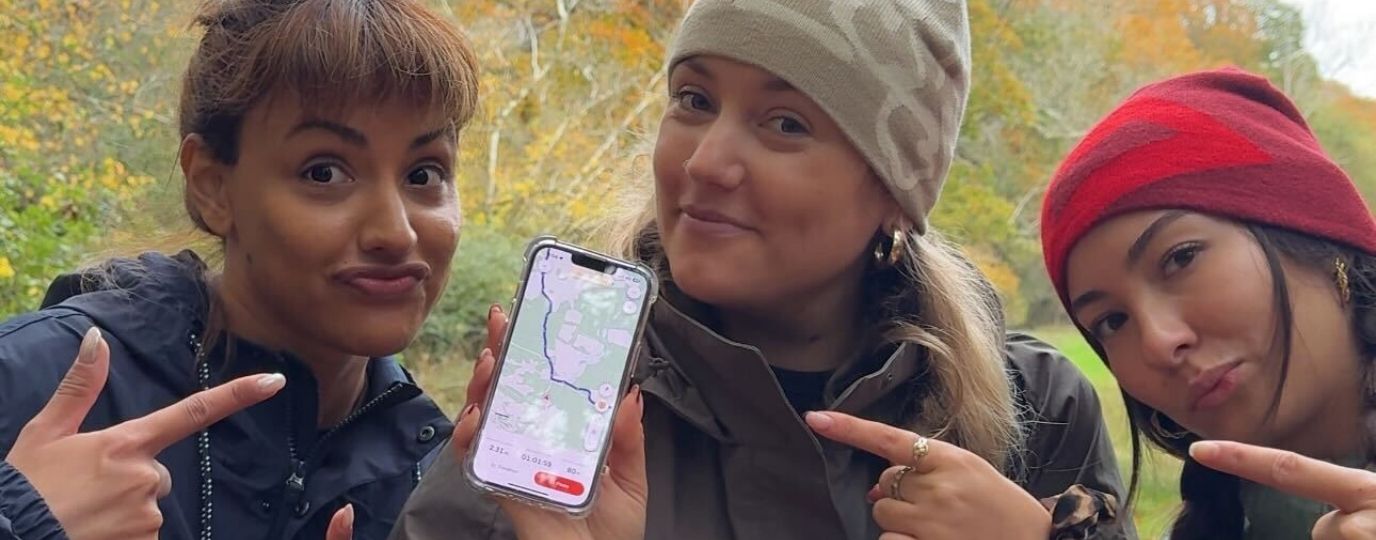 3 girls on a hike with phone