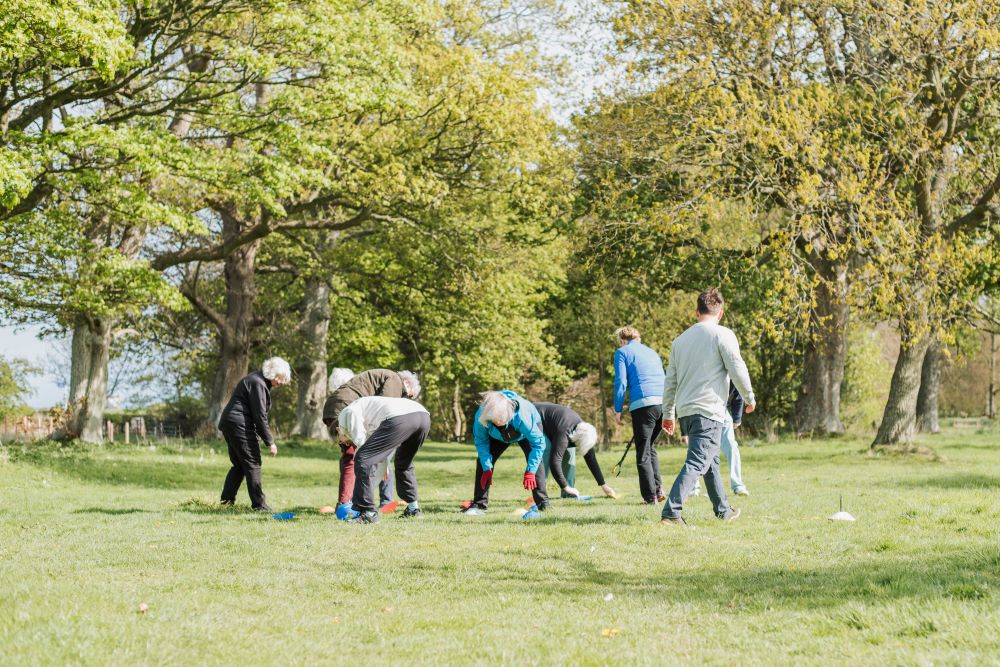 A movement class - people outside playing with beanbags