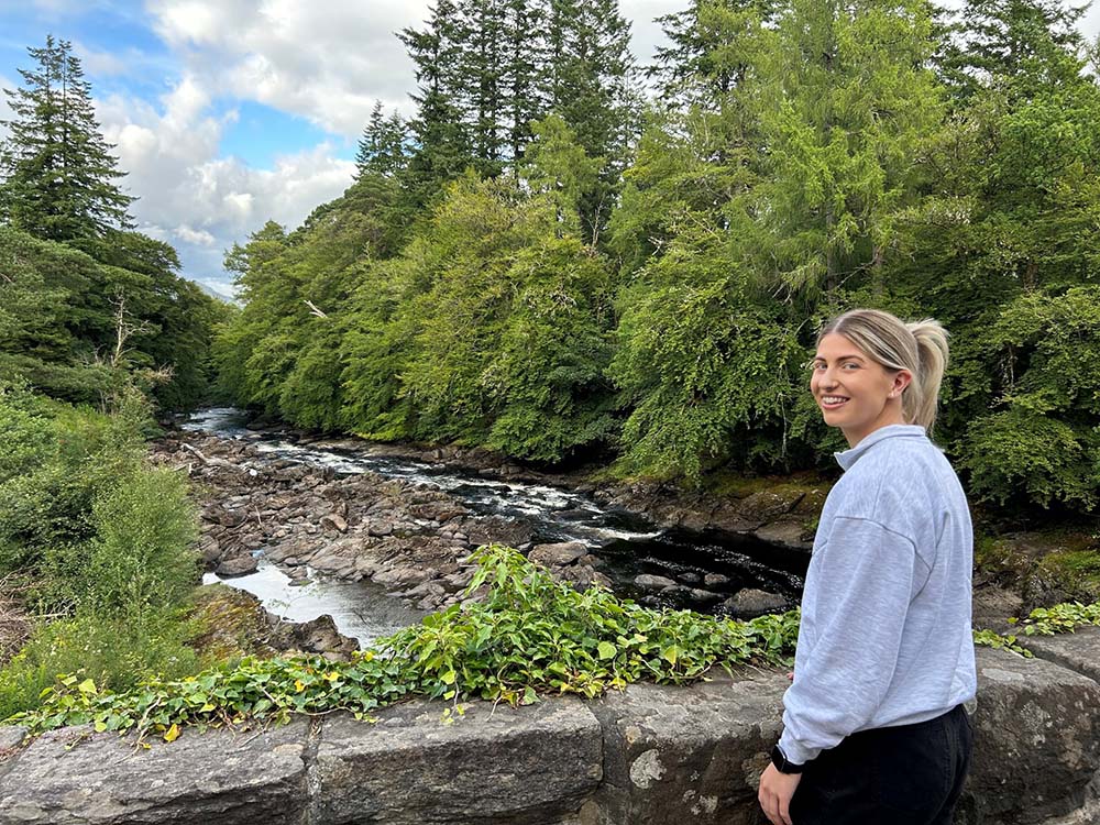 a woman looks back while in strathyre on the rob roy way