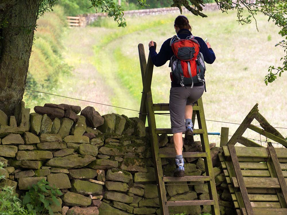 Stile on hadrians wall with a hiker
