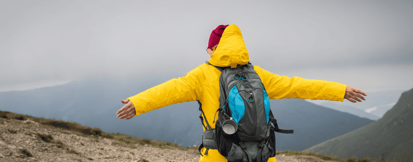 wind speed woman enjoying the wind in a yellow jacket