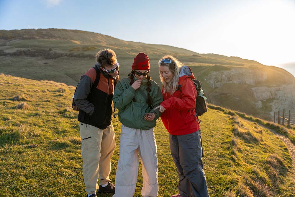 a group of young hikers on a cliff