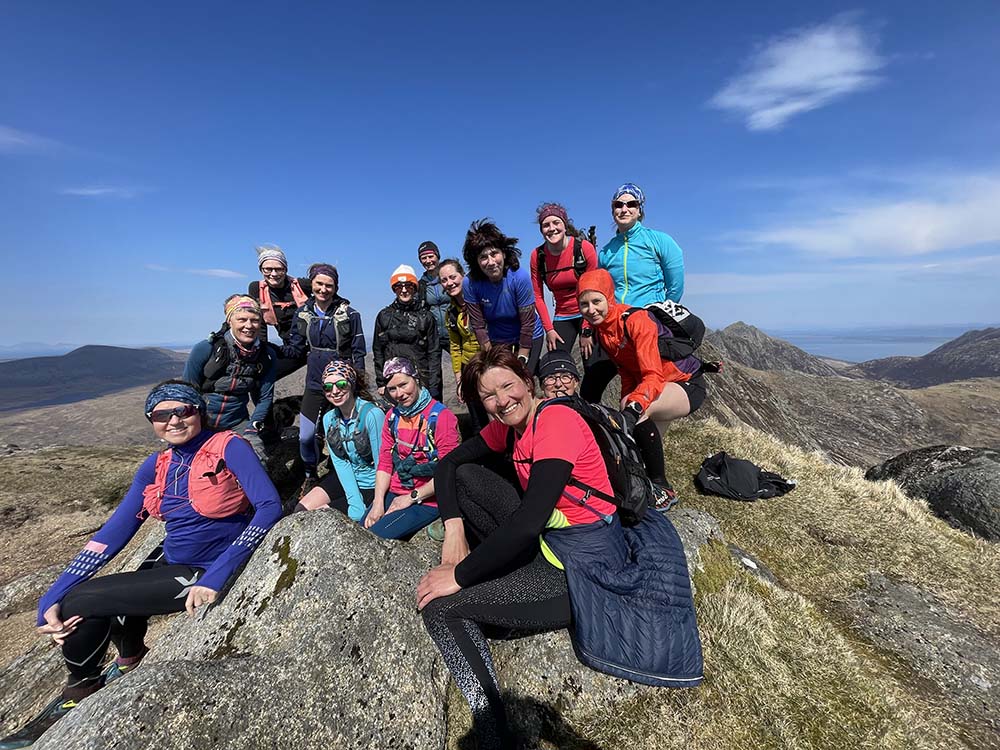 women together on top of a mountain