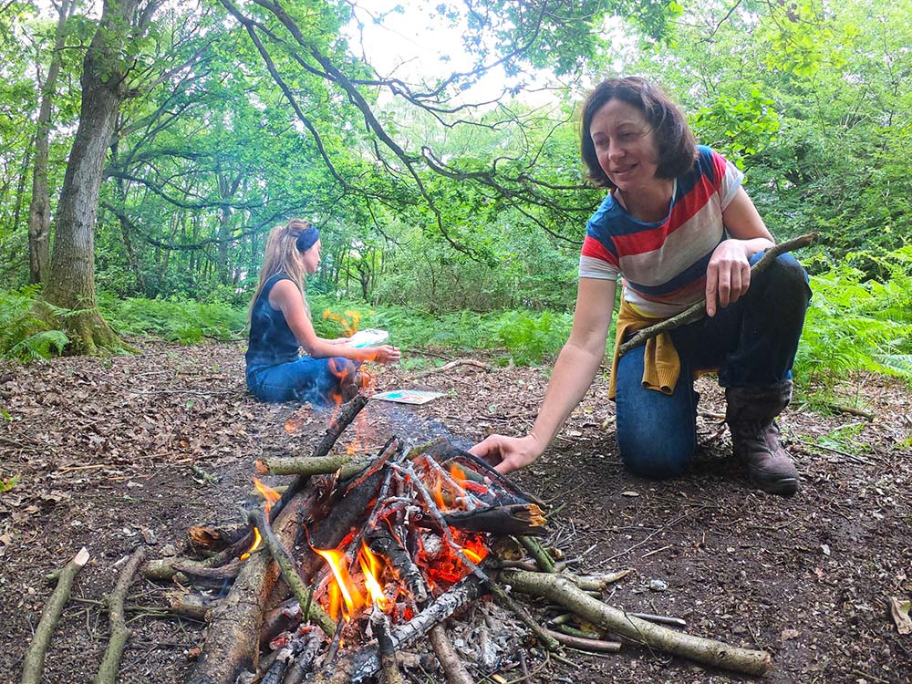 lighting a fire in woodland