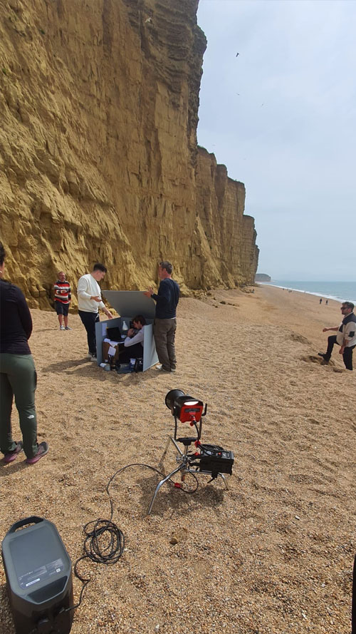 Filming crew on a beach