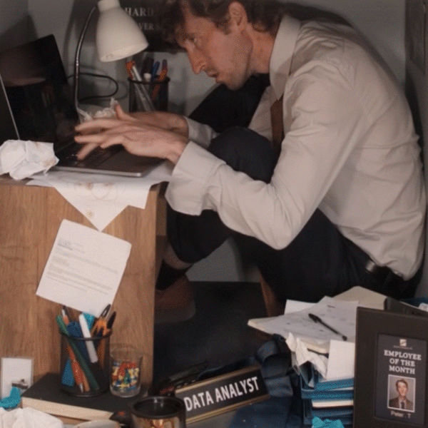 workaholic man squashed in a box