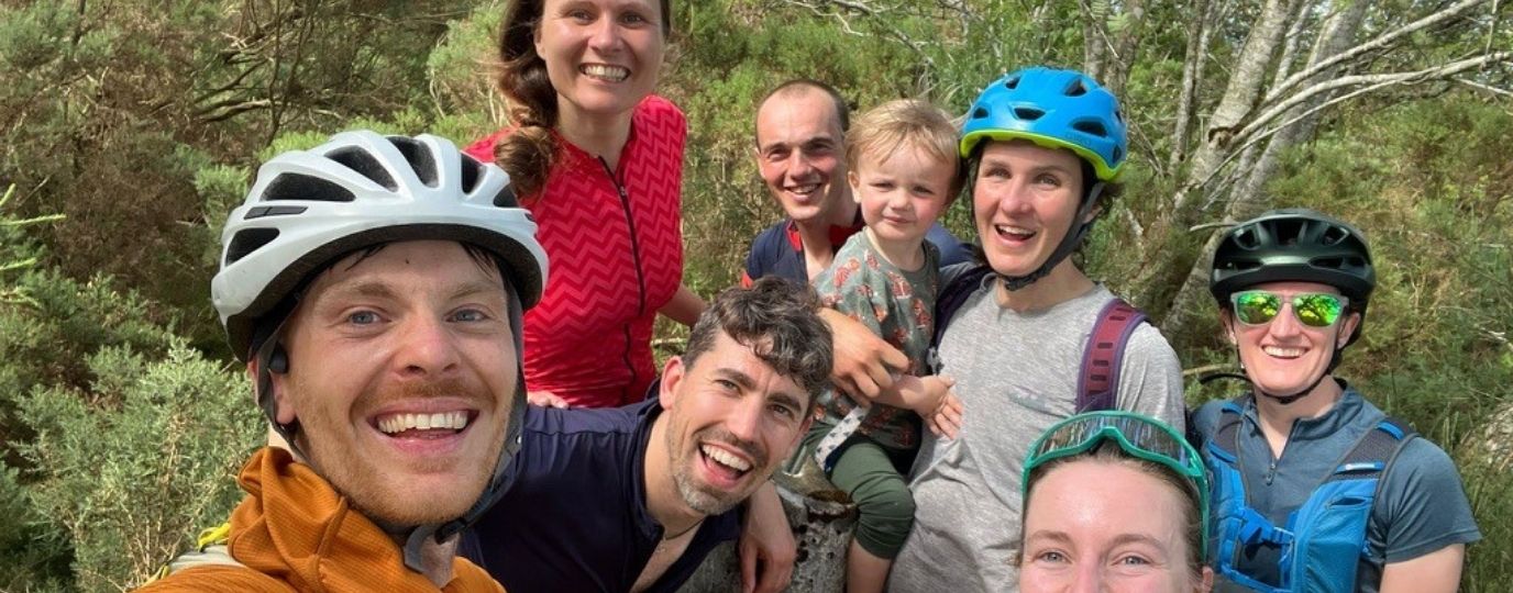a family group around a trig pillar
