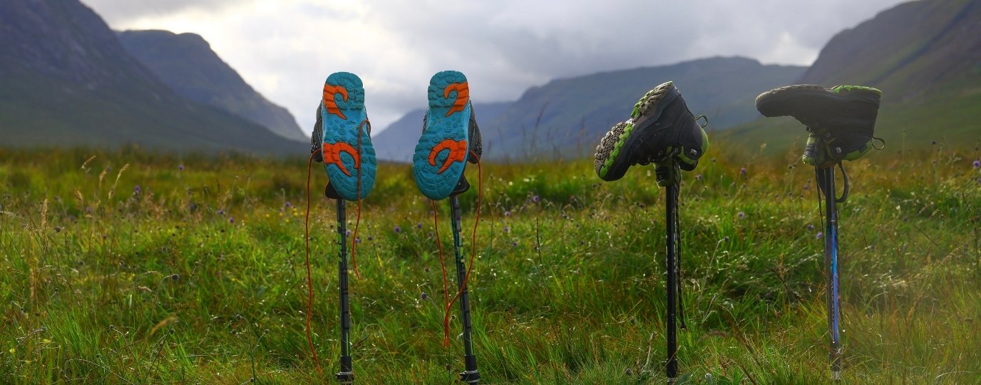 hiking boots on walking poles in scottish highlands
