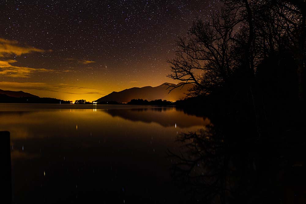 Orange skies and stars above Derwentwater in the Lake District