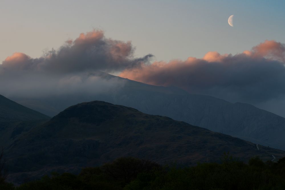 Clouds and a half moon over Snowdonia