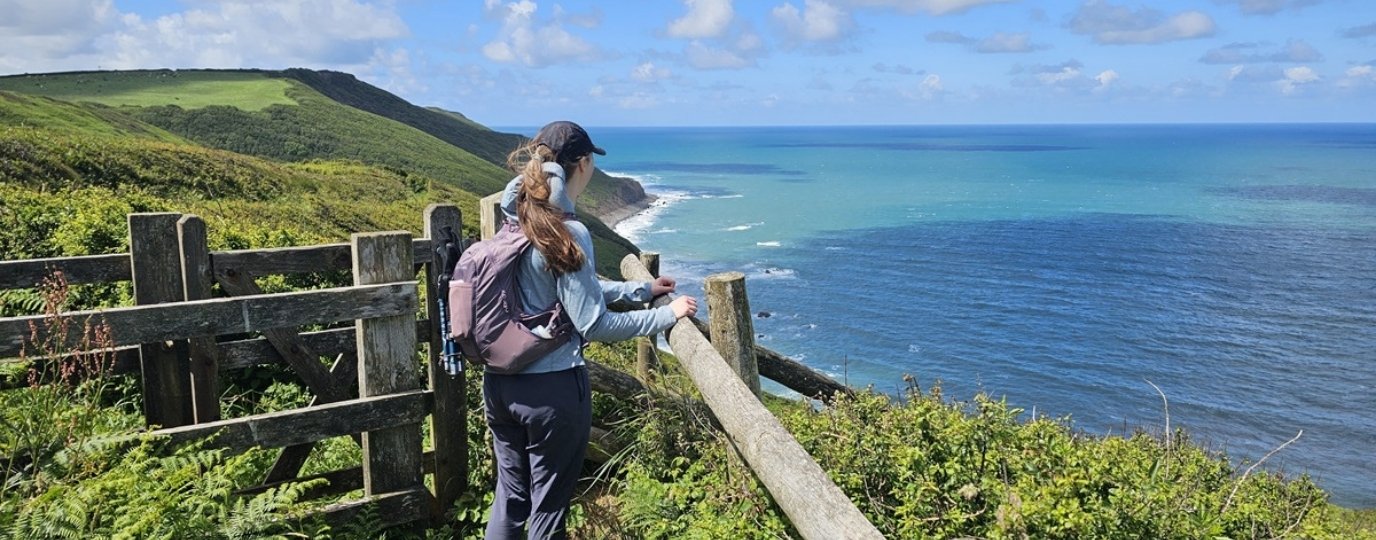 A woman on the cornish coast staring out to sea